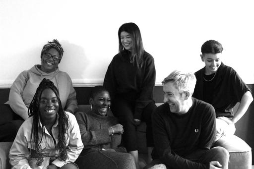 Act Build Change team smiling in black and white.